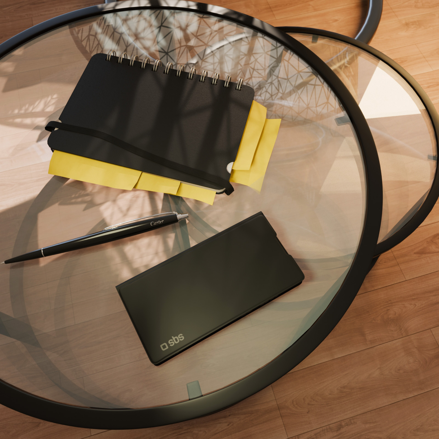 A black notebook with yellow sticky notes, a pen, and a tablet are on a glass table. Wooden floor in the background.