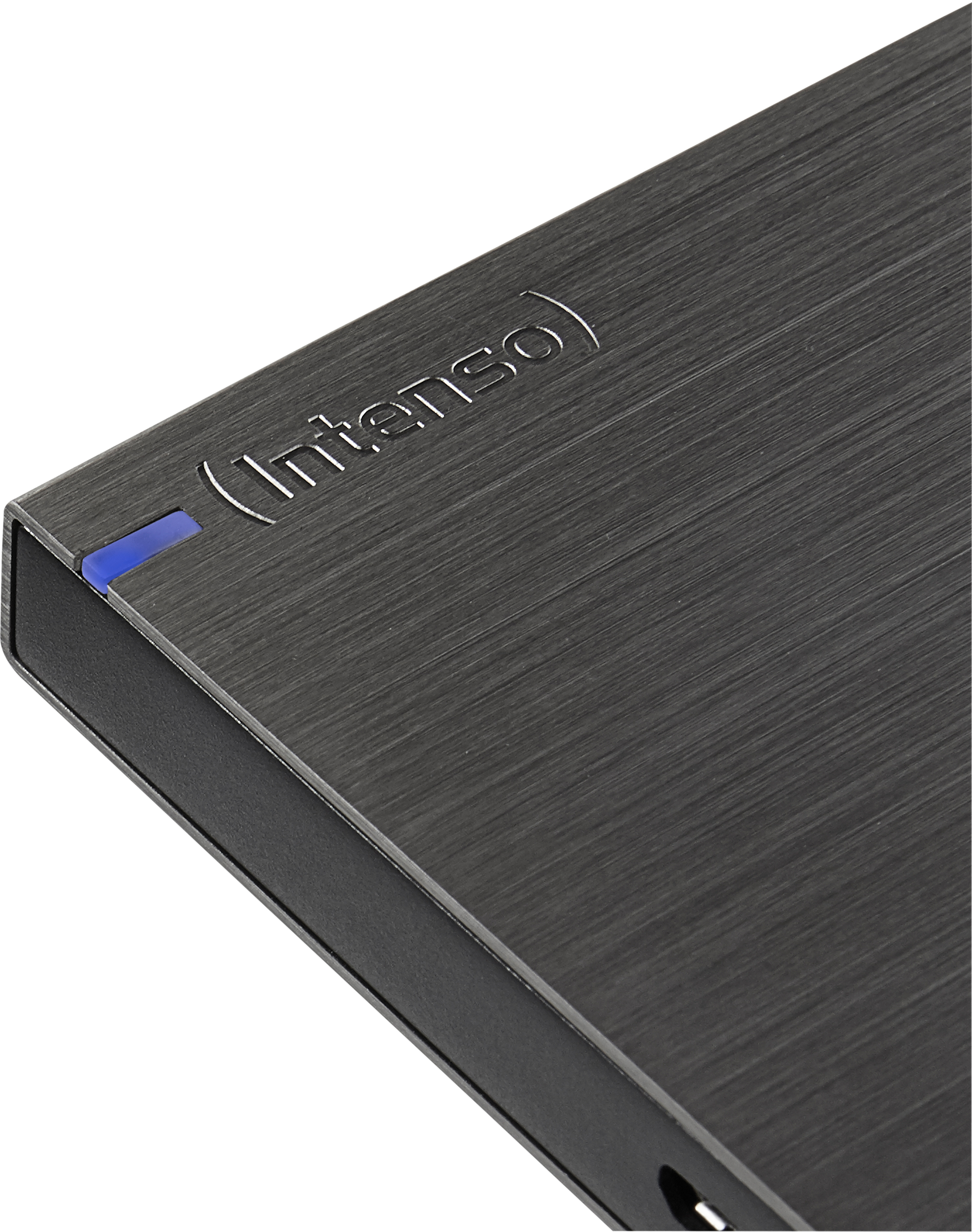 Gros plan d'un disque dur externe Intenso gris foncé. La marque est en relief. Une lumière bleue est allumée.