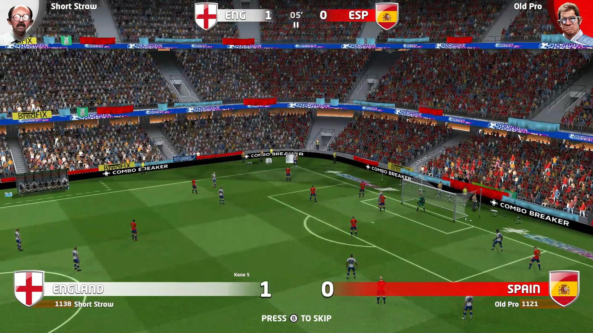 Ein Fußballspiel im Gange. England führt 1:0 gegen Spanien. Spieler in roten und weißen Trikots auf einem grünen Feld im Stadion.