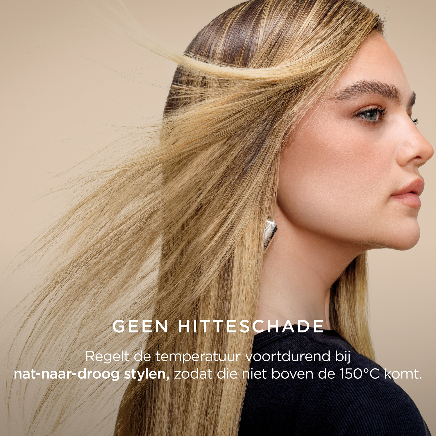 A woman with blonde hair styled to the side, wearing a black shirt and silver earrings, on a beige background.