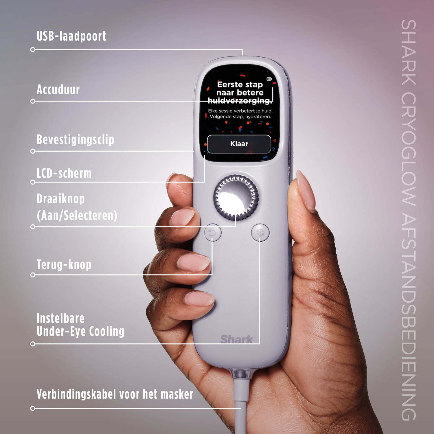 A hand holds a gray Shark Cryoglow remote. It has a screen, buttons, and a cable.