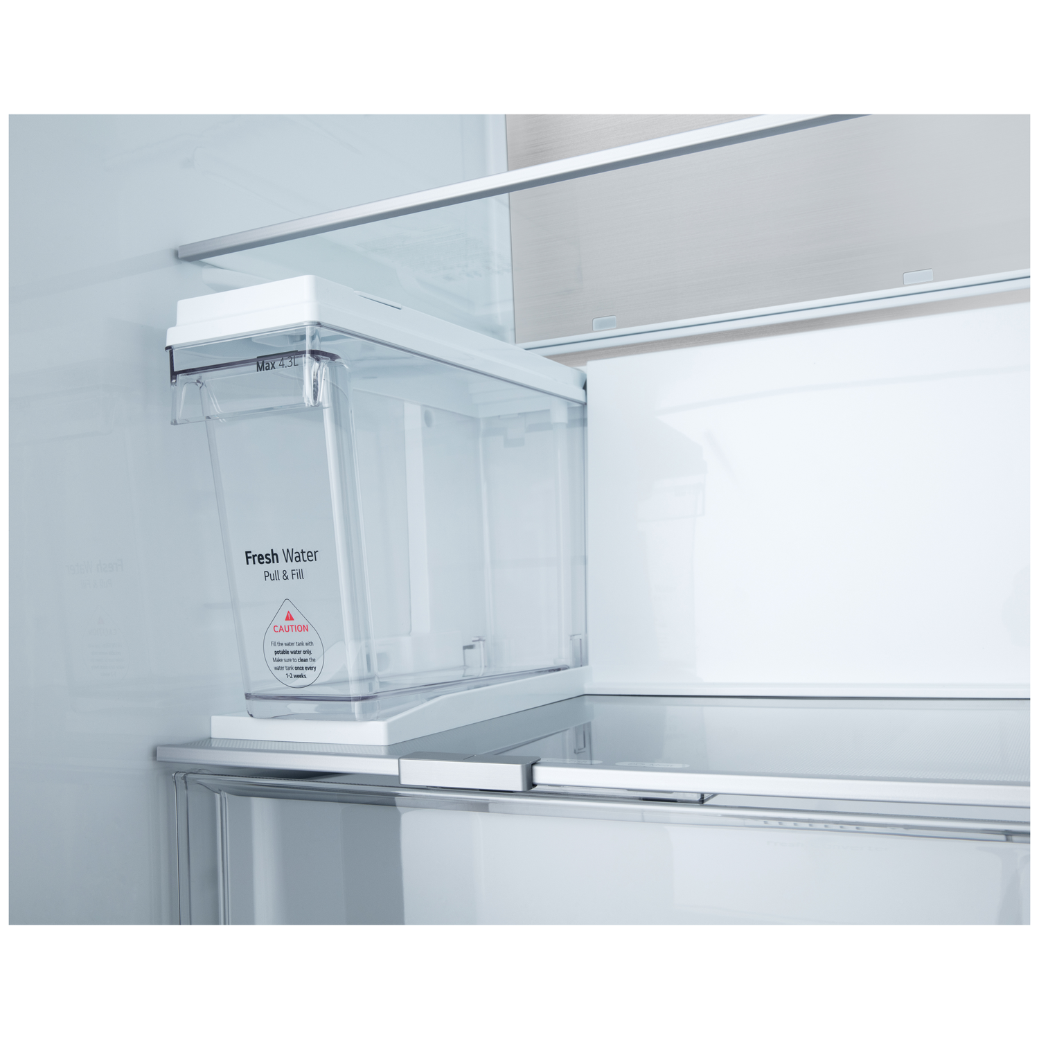 Inside a refrigerator, a clear water tank with text 'Fresh Water'. It's mounted on a shelf. The background is white.