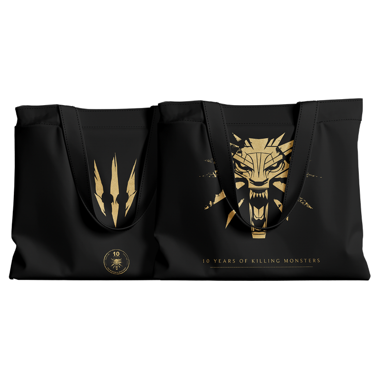 Czarne torby z złotymi wzorami. Jedna ma głowę wilka, druga symbol. Tekst: 10 lat zabijania potworów.