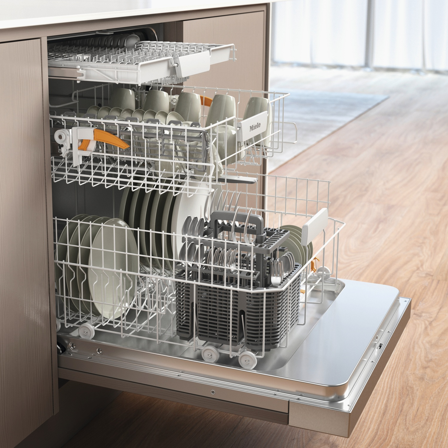 Open dishwasher with dishes inside, including plates, cups, and utensils. Silverware basket visible. Wooden floor and cabinet in background.