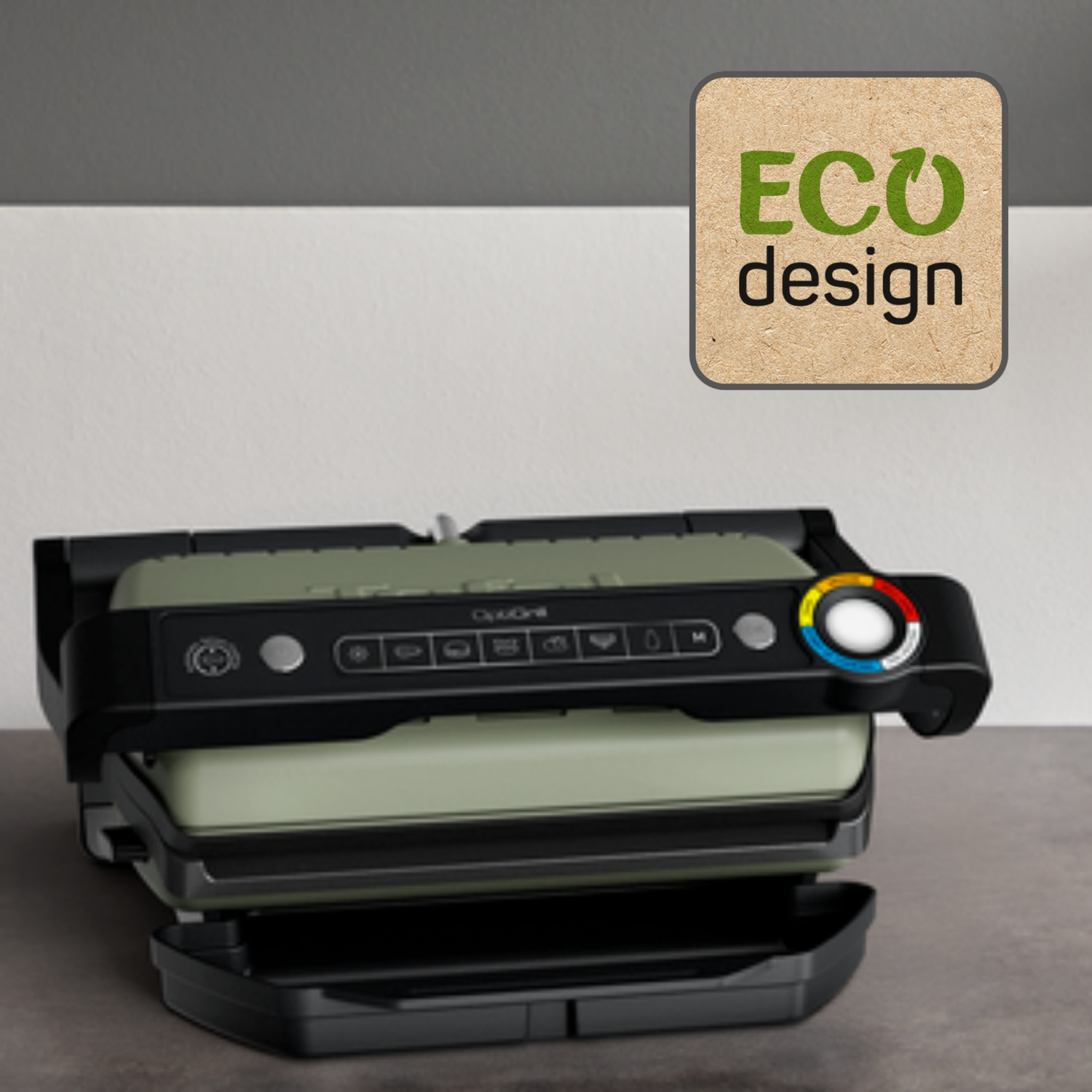 Un OptiGrill, vert et noir, sur une surface grise. Une étiquette Eco Design est dans le coin supérieur droit.