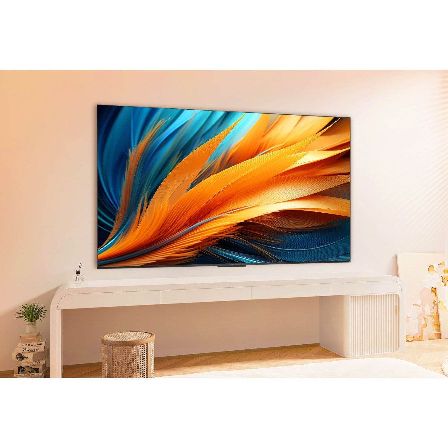 Un moderno soggiorno con una grande TV che mostra arte astratta, una scrivania bianca, uno sgabello e qualche decorazione.