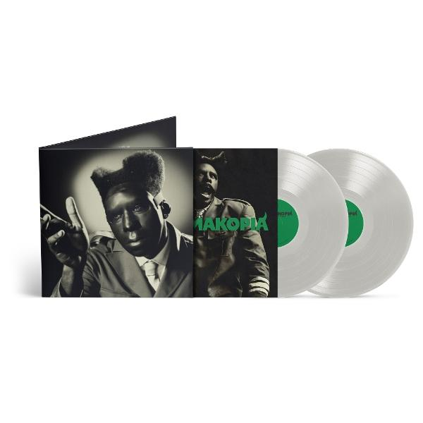 Album cover and two vinyl records. The cover features a man in a suit. Records are silver with green labels.