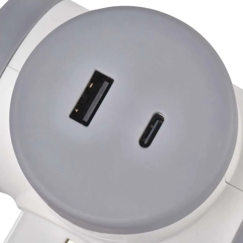 Egy fehér és szürke készülék közelképe. Két fekete USB-portja van egy szürke, kör alakú felületen.