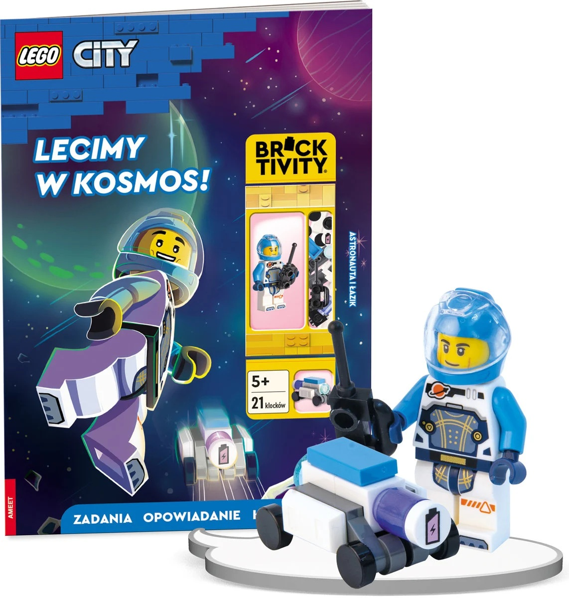 Motyw kosmiczny Lego City. Książka, figurka astronauty i mały łazik kosmiczny są wystawione, wszystko produkty Lego.