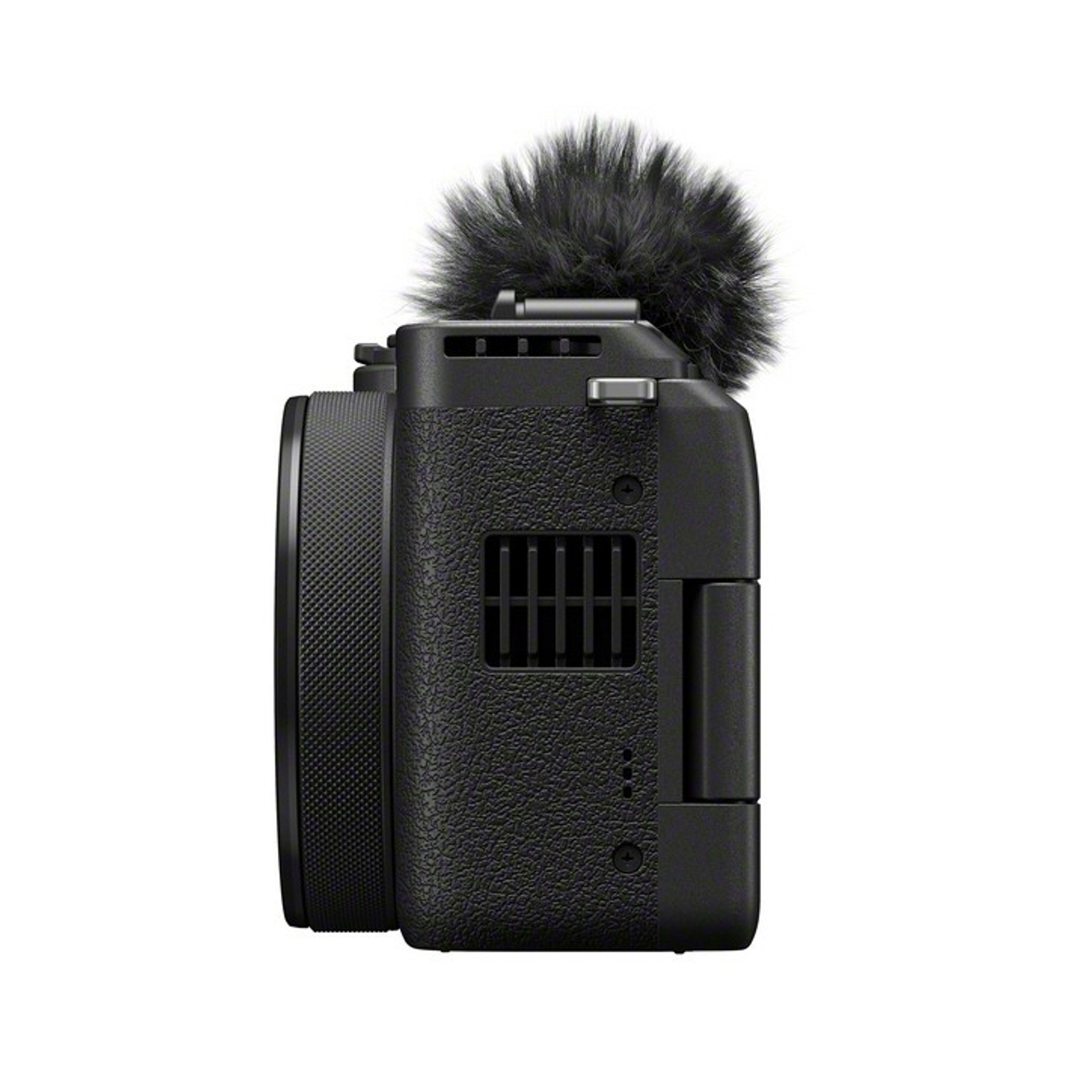 Fotocamera nera con microfono peloso. L'obiettivo è a sinistra, il corpo ha un'impugnatura strutturata.