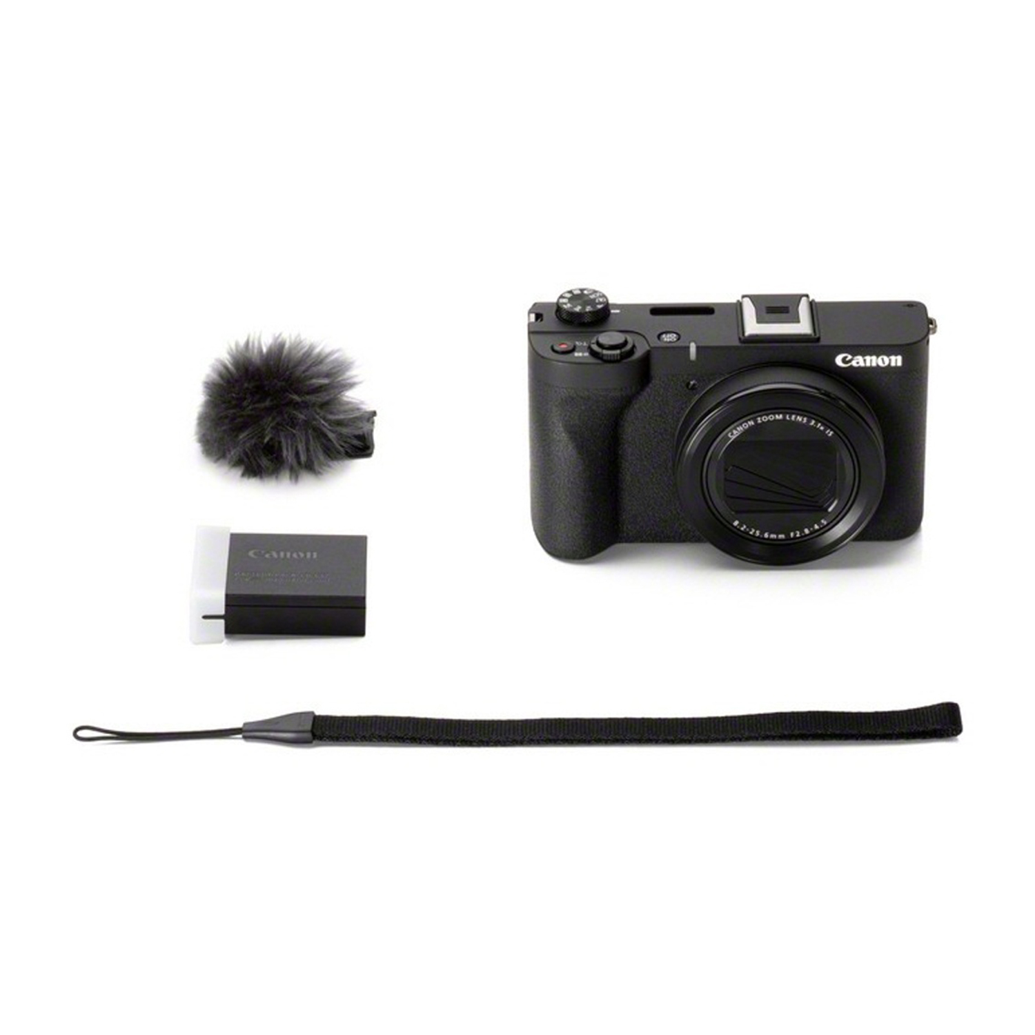 Una fotocamera Canon nera con accessori tra cui una copertura per microfono, caricabatterie e cinturino da polso su sfondo bianco.