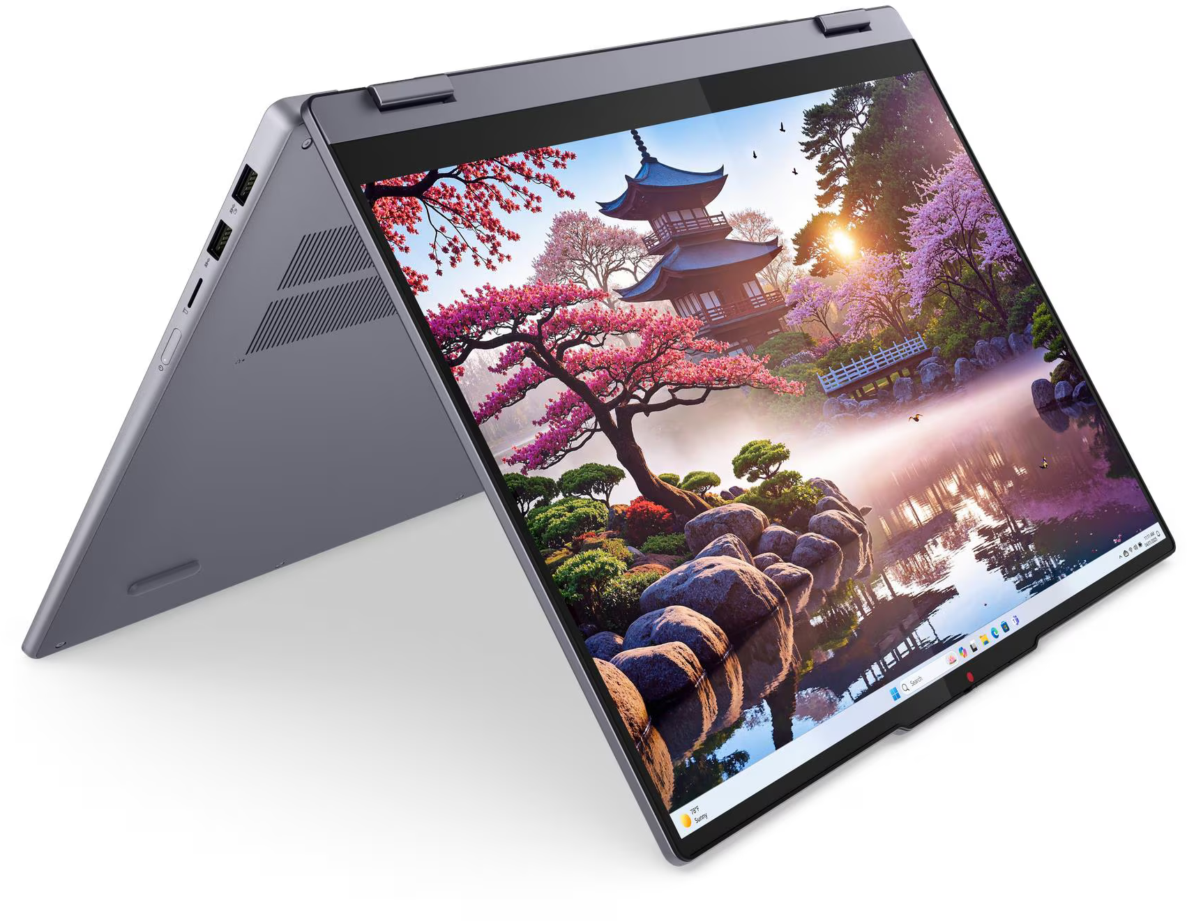 A laptop képernyője egy japánkert jelenetét mutatja pagodával, rózsaszín fákkal, vízzel és sziklákkal. A laptop szürke és nyitott.