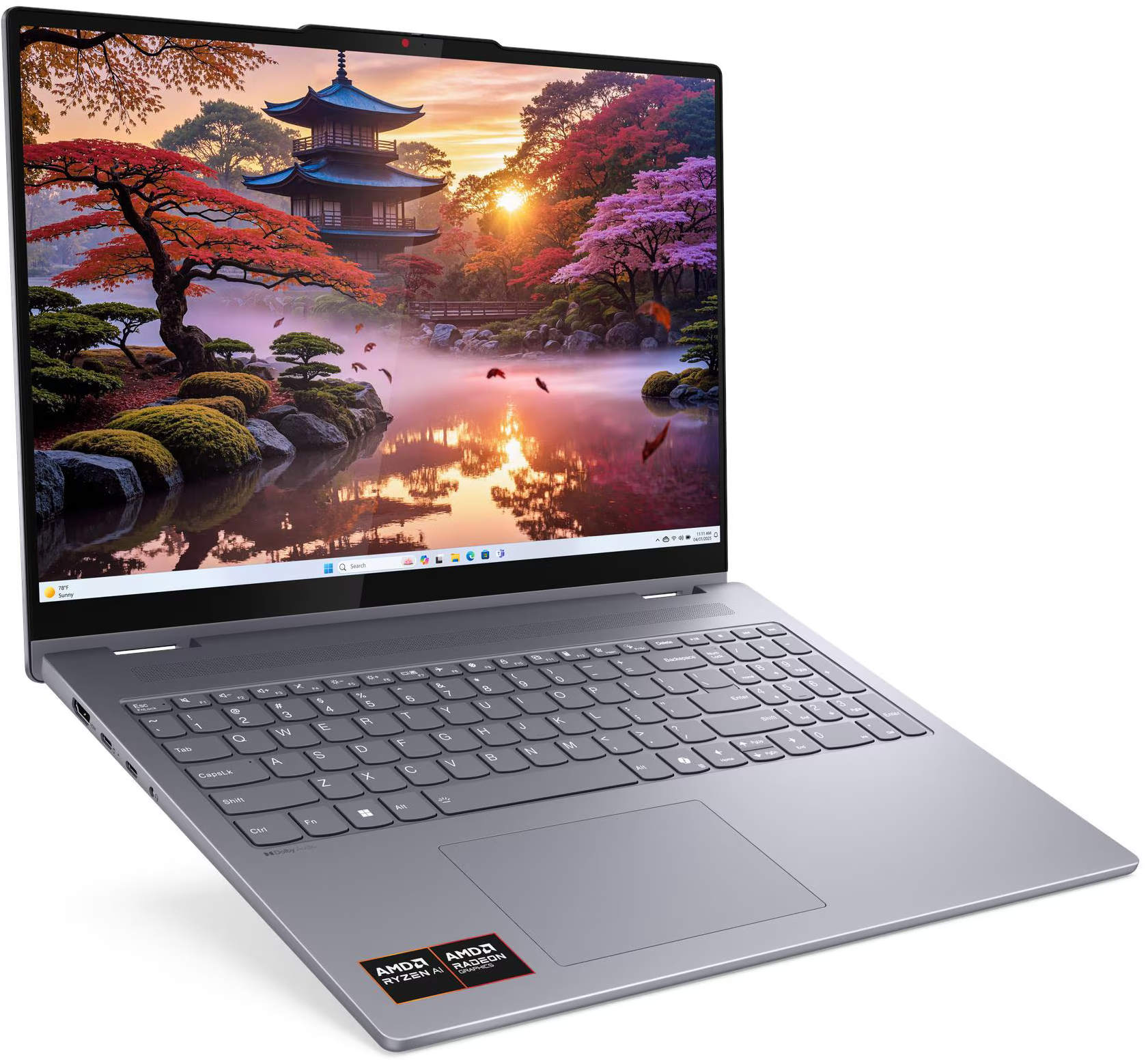 A laptop egy japán kertet jelenít meg pagodával, fákkal és tóval. A laptop szürke, billentyűzettel és érintőpaddal.