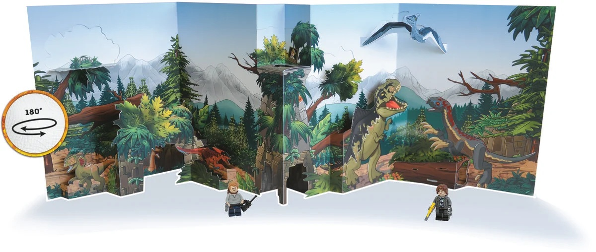Scena pop-up z dinozaurami, drzewami i górami. Dwie figurki Lego stoją z przodu. Pterodaktyl leci nad nimi.