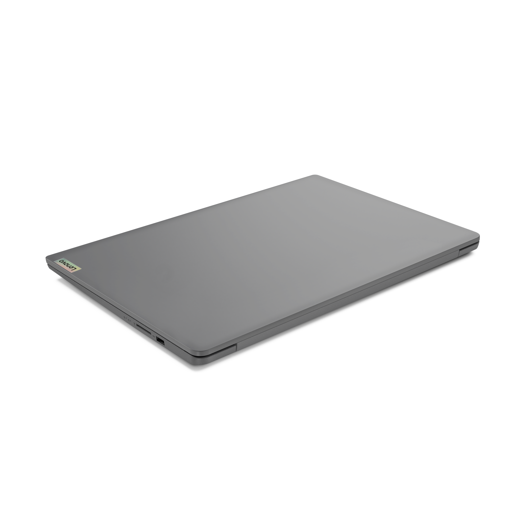 Zamknięty szary laptop Lenovo. Ma logo Lenovo i porty z boku. Tło jest czarne.