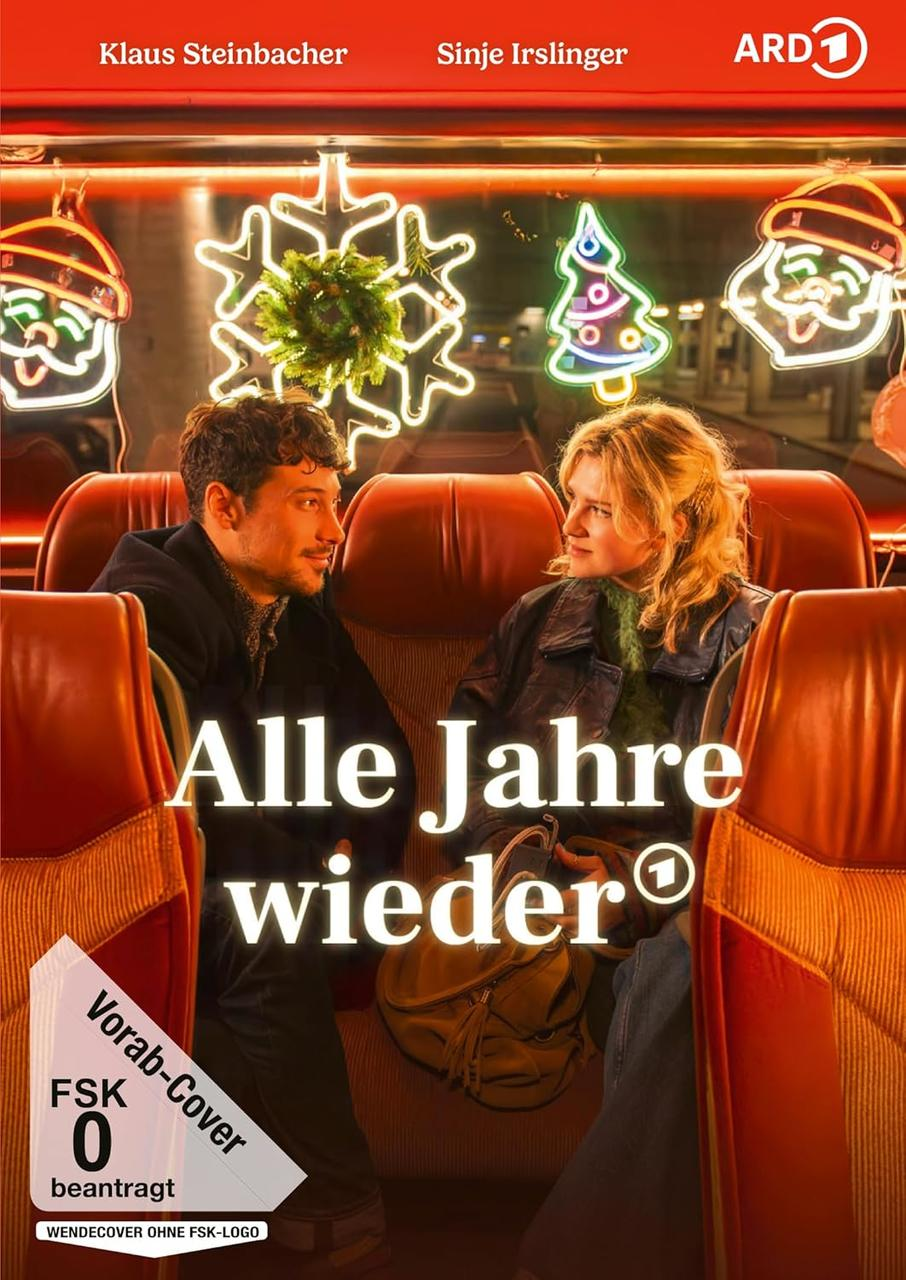 Ein Filmplakat zeigt zwei Personen in einem Zug. Weihnachtsbeleuchtung ist sichtbar. Der Titel lautet 'Alle Jahre wieder'.