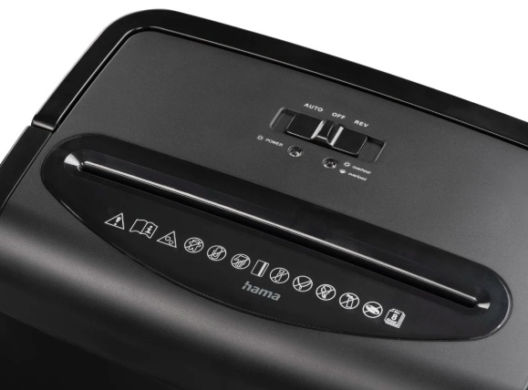 Czarna niszczarka do papieru z góry. Posiada szczelinę, przełącznik (Auto, Off, Rev) i symbole ostrzegawcze. Widoczne logo 'Hama'.