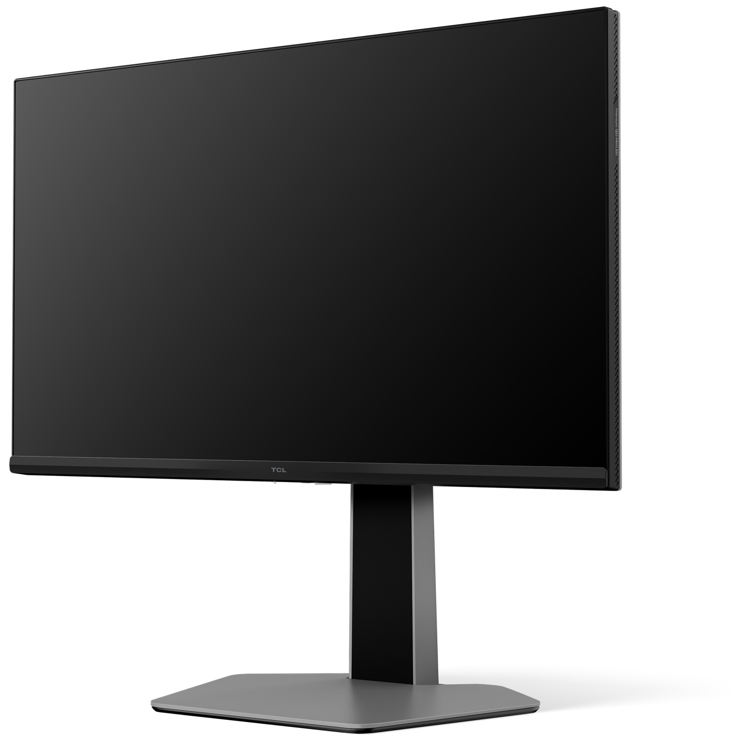 Un moniteur TCL noir sur une base grise. L'écran est sombre. Le support est noir et gris. Le fond est blanc.