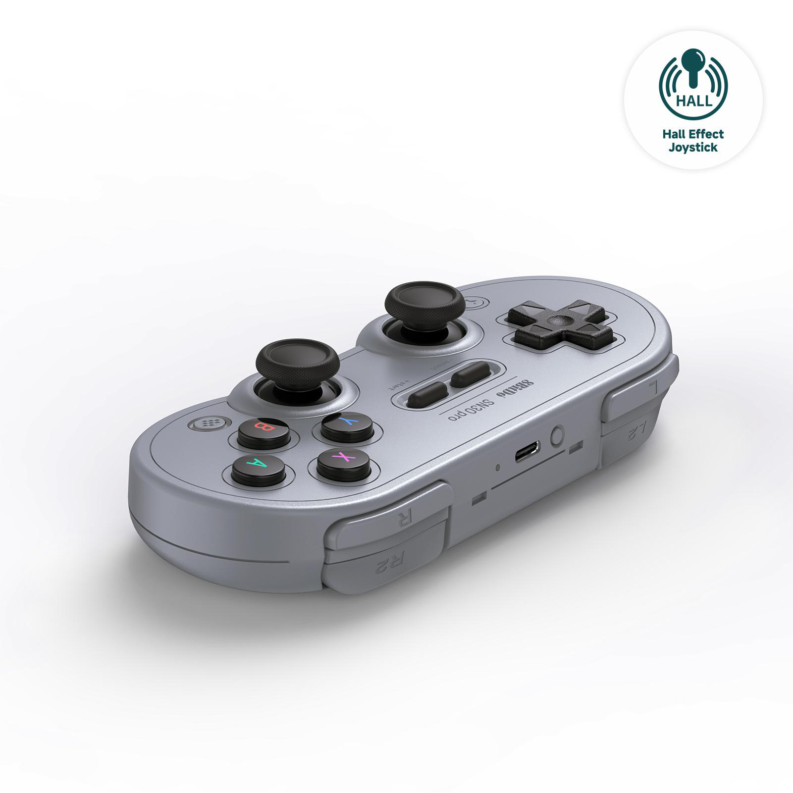 Ein silberner Gamecontroller mit schwarzen Joysticks und Knöpfen. Er hat eine ovale Form und einen weißen Hintergrund.