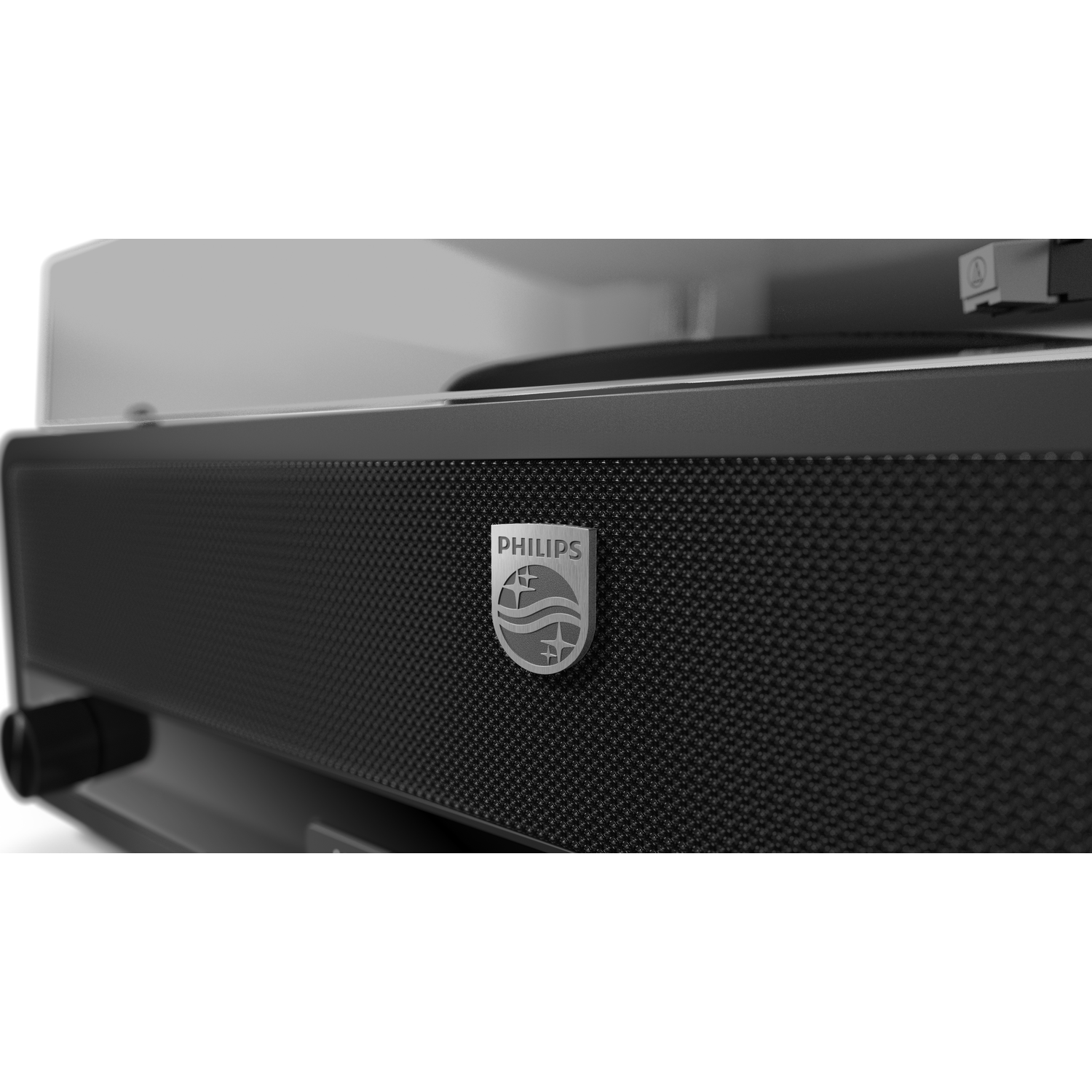 Close-up of a black Philips record player. The Philips logo is visible. The turntable and arm are in the background. The surface is textured.