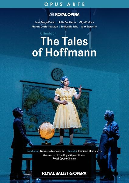 Plakat für The Tales of Hoffman. Eine Frau in gelbem Kleid steht auf der Bühne. Zwei Männer schauen sie an. Ein Globus und eine Weltkarte sind im Hintergrund.