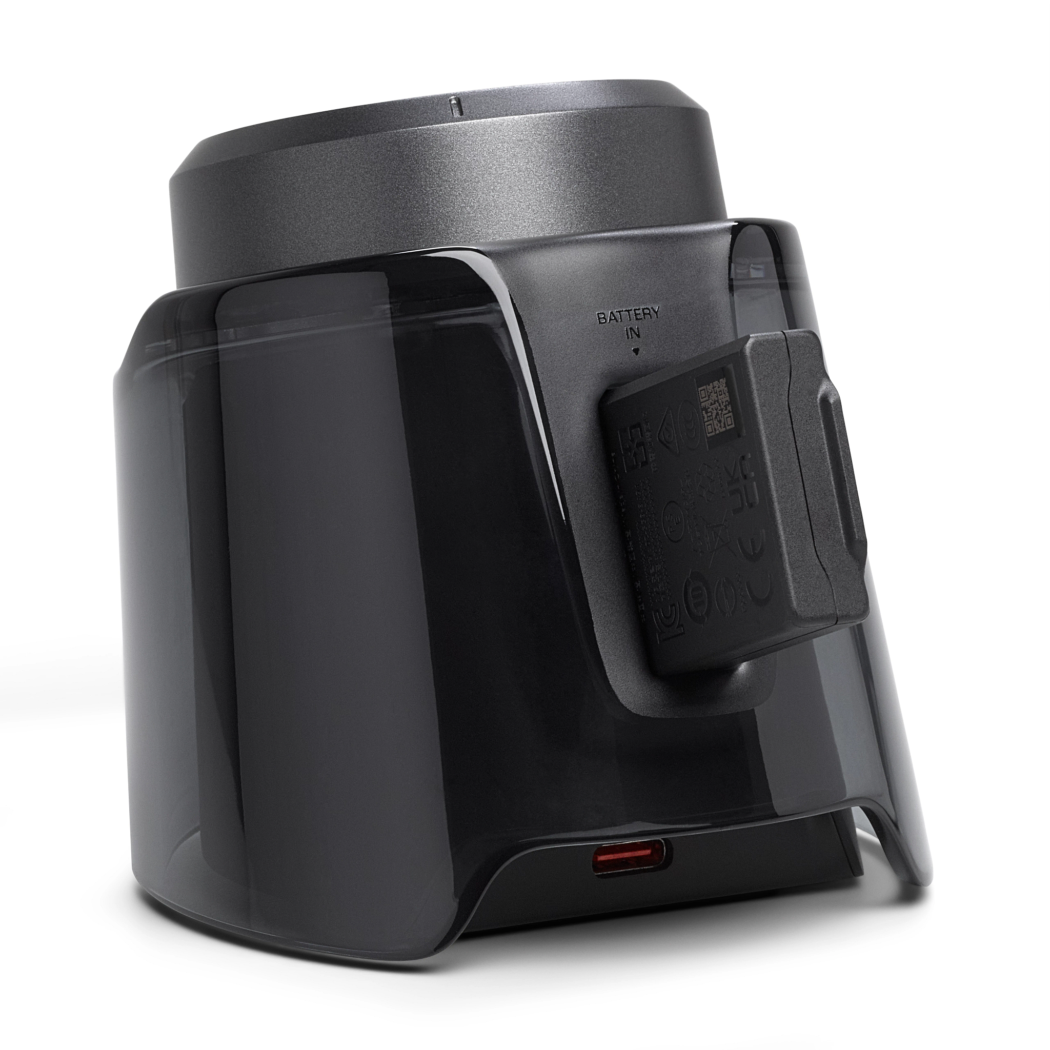 Eine schwarze Ladestation mit Akku und USB-C-Anschluss. Die Dockingstation hat eine transparente Kunststoffabdeckung. Weißer Hintergrund.