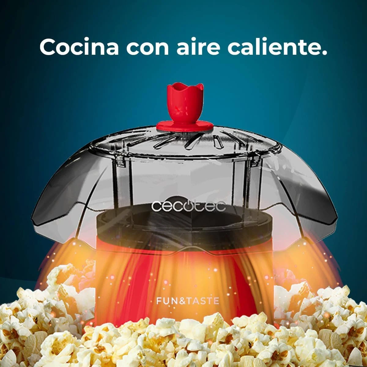Máquina de palomitas con base roja, tapa transparente y flor roja. Palomitas rodean la base. Texto: Cocina con aire caliente.