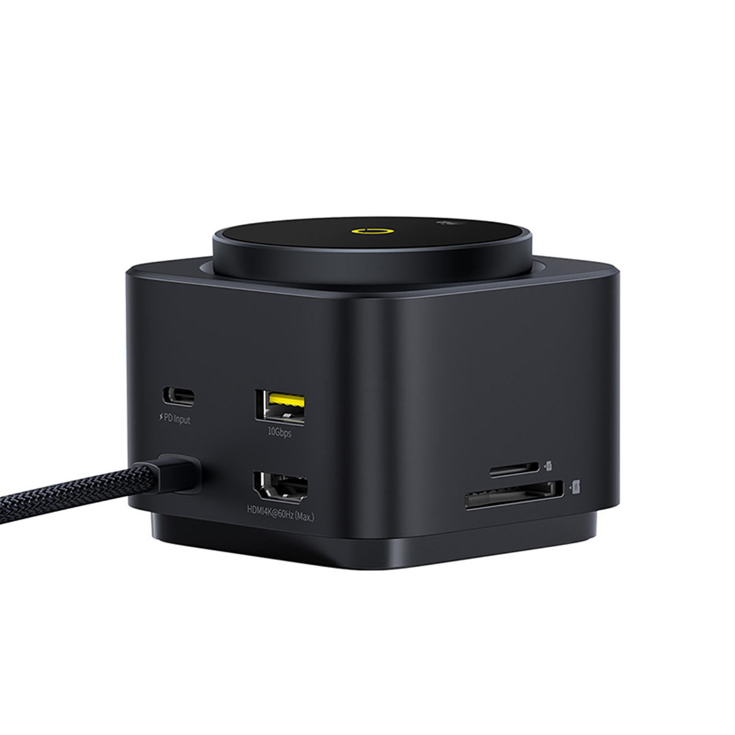 Hub USB negro con múltiples puertos: entrada PD, USB, HDMI y lector de tarjetas. Un cable está enchufado. La parte superior tiene un diseño circular.