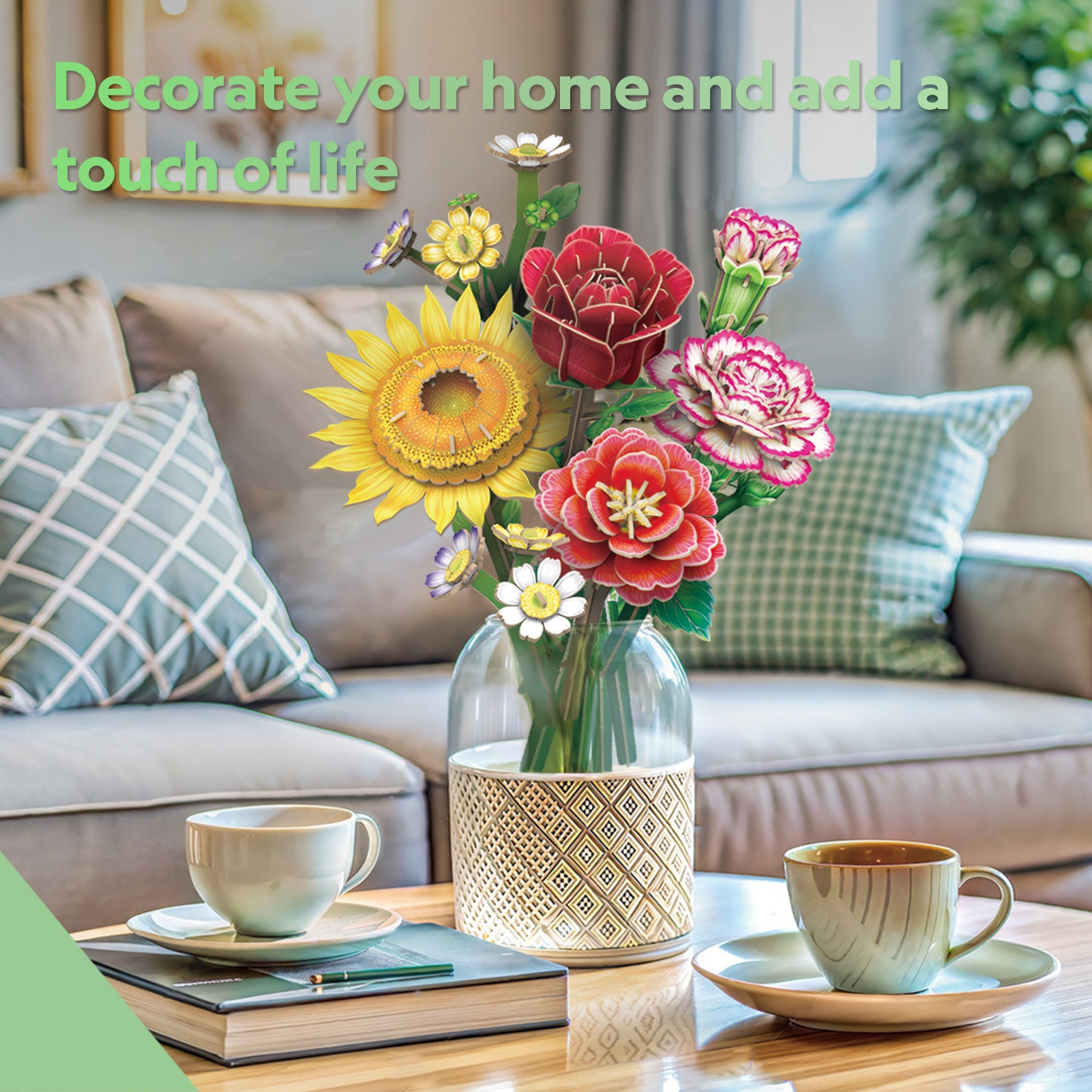 Kolorowy bukiet papierowych kwiatów w wazonie na stole. Widoczne są dwa filiżanki i spodki.