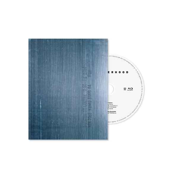 A Blu-ray disc partially out of its case. The case is blue with vertical lines. The disc is white with text and logos.
