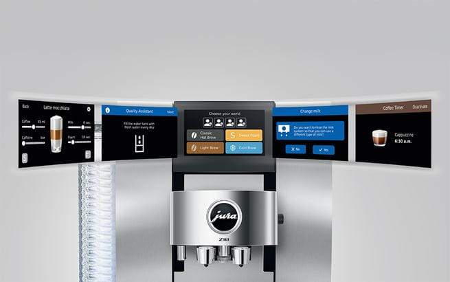 Ekspres do kawy z wieloma ekranami wyświetlającymi opcje napojów i ustawienia. Maszyna ma srebrne wykończenie i logo Jura.