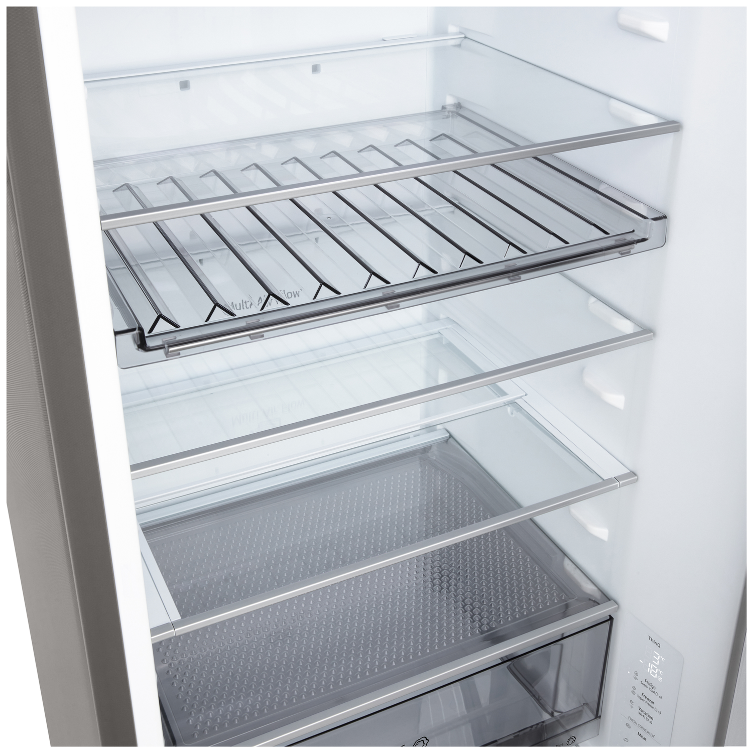 Inside a refrigerator, showcasing glass shelves and metal racks. The interior is clean and empty, with a control panel on the side.