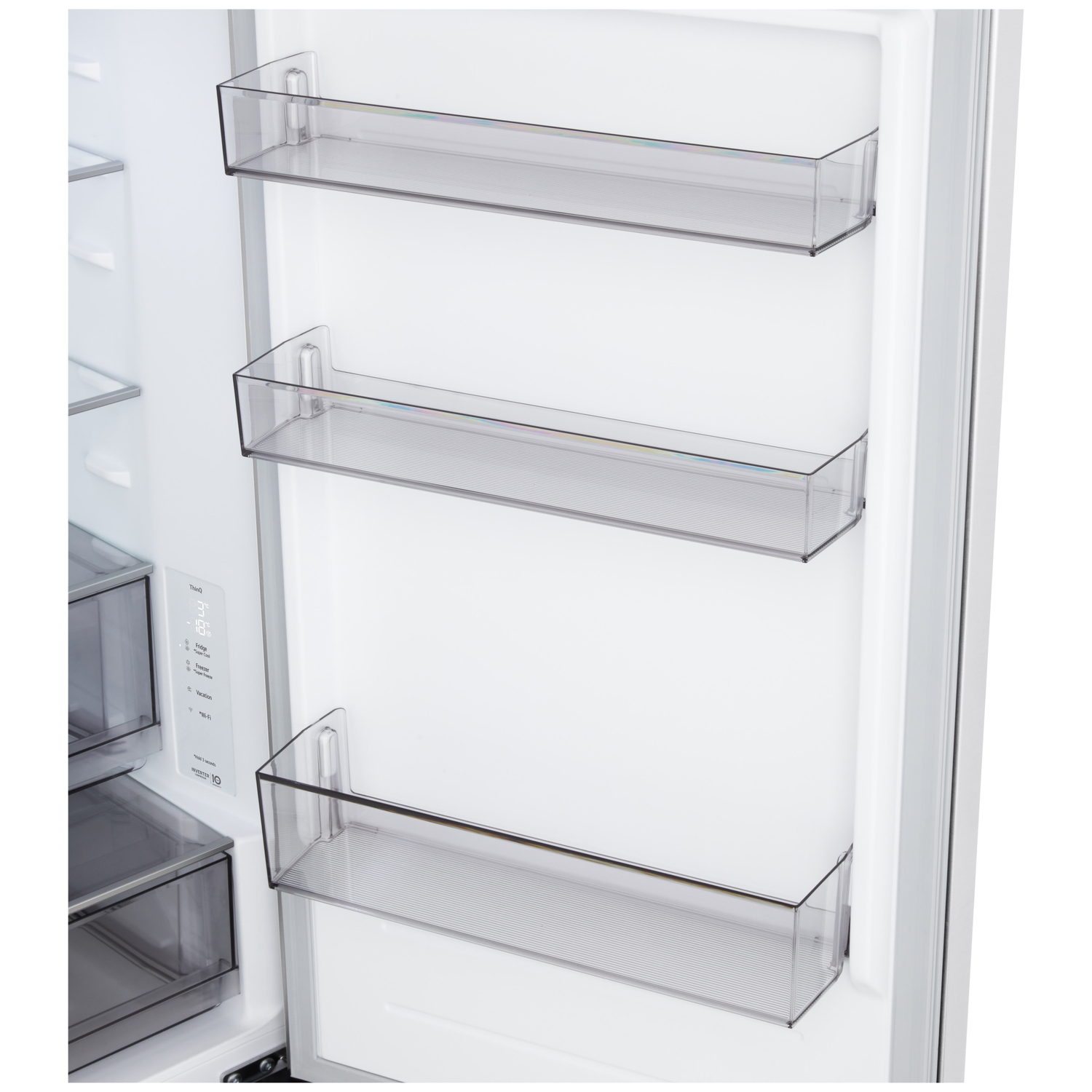 Open refrigerator door interior. Clear plastic shelves are visible. Fridge door has a digital display and storage drawers.