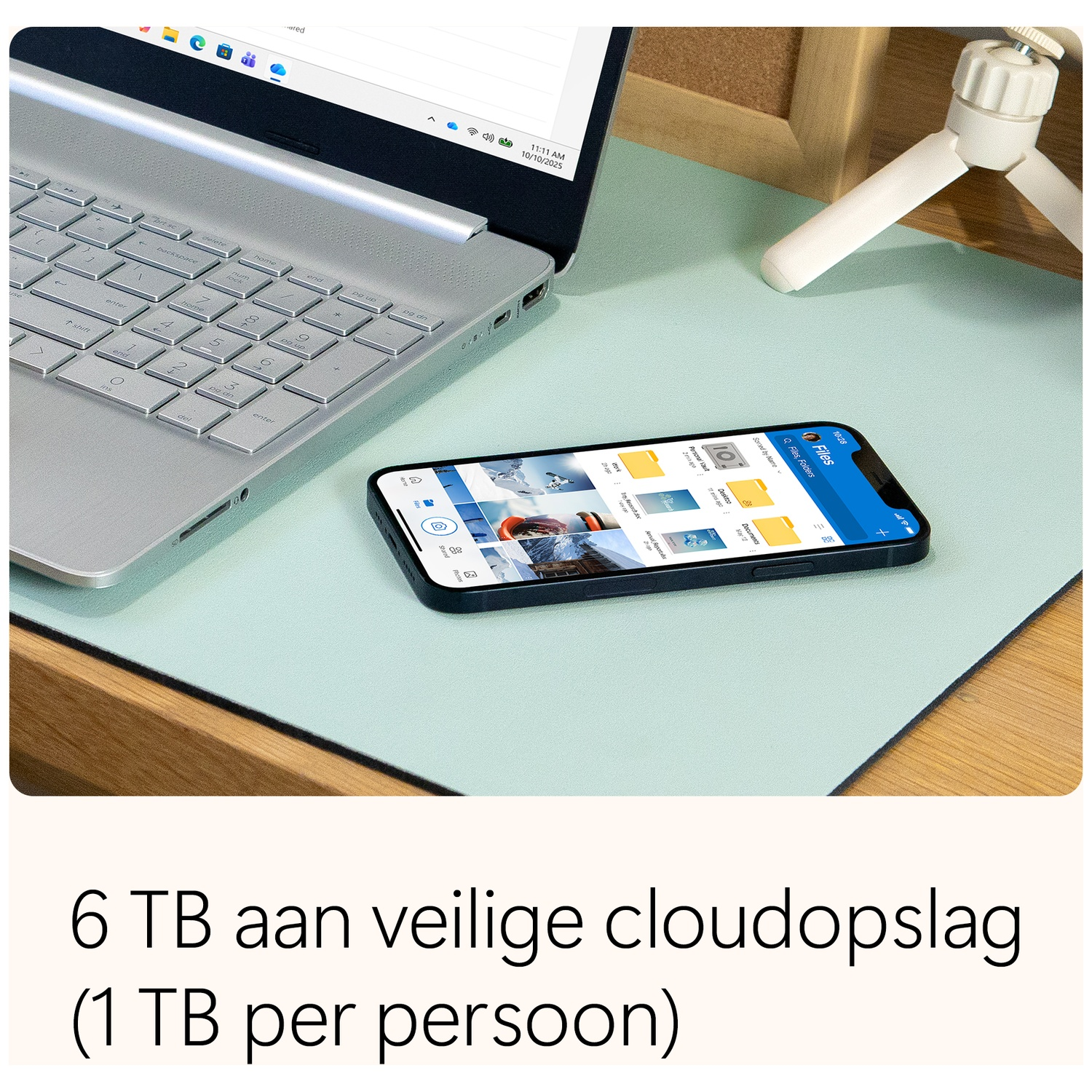 Laptop and phone on a desk, the phone displays file folders. Text on the bottom reads '6 TB of secure cloud storage'.