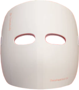 Weiße Gesichtsmaske mit roten Augenöffnungen. Die Maske dient der Lichttherapie. Der Markenname ist sichtbar.
