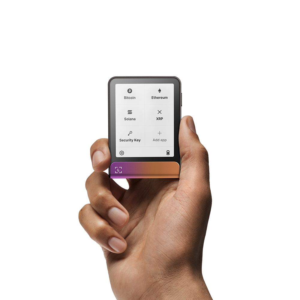 Eine Hand hält ein schwarzes Gerät, das Kryptowährungsoptionen wie Bitcoin und Ethereum anzeigt. Das Gerät hat eine farbige Unterseite.