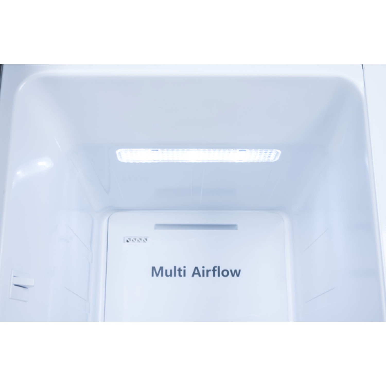 Inside a refrigerator. The interior is white with a light at the top. The words 'Multi Airflow' are printed on a white panel.