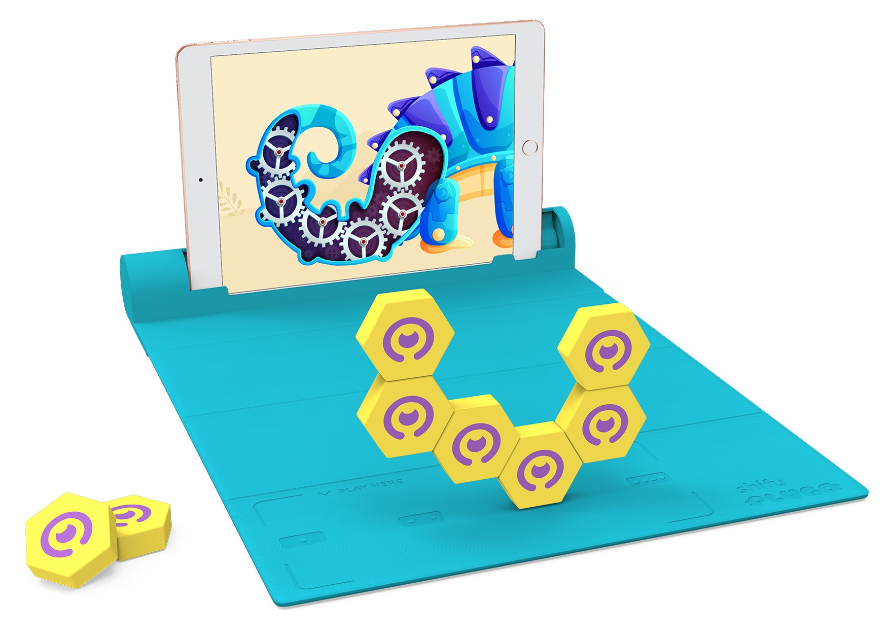 Tablet wyświetla niebiesko-fioletową jaszczurkę. Żółte klocki z fioletowymi oczami na niebieskiej macie, ze stojakiem.