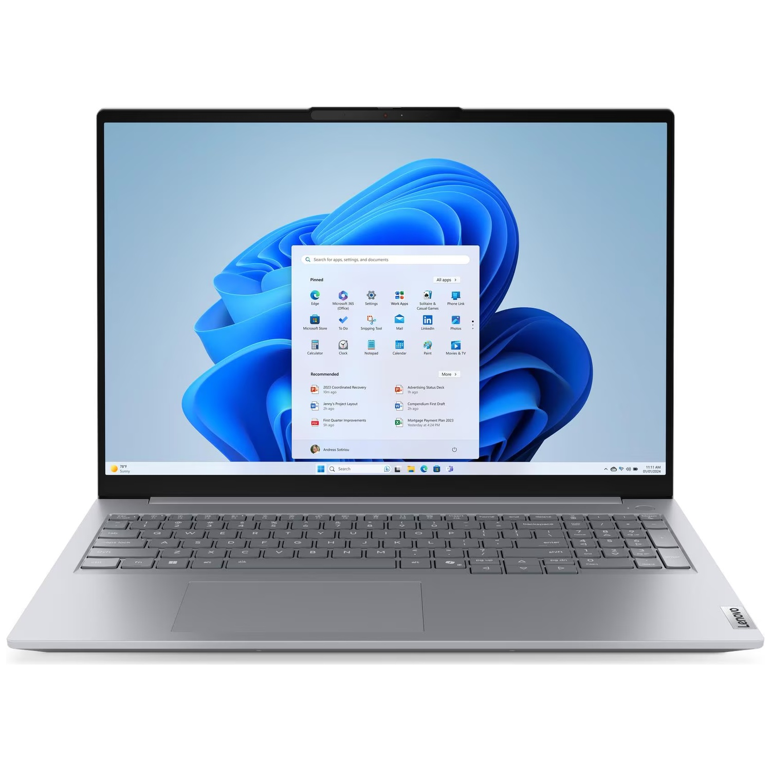 Un ordinateur portable Lenovo affiche le menu Démarrer de Windows 11. L'écran montre des icônes d'applications et un fond bleu. Clavier et pavé tactile visibles.
