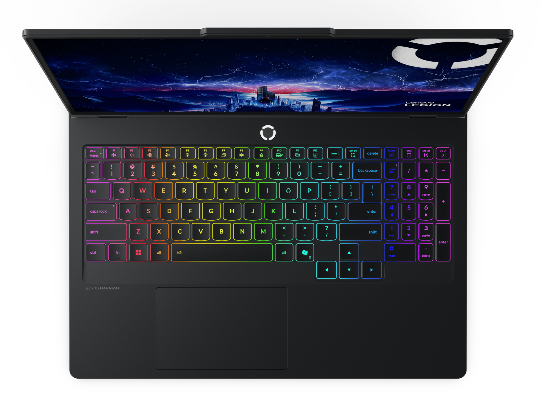Klawiatura laptopa podświetlona tęczowymi kolorami. Ekran wyświetla nocne niebo nad miastem. Marka Lenovo Legion.
