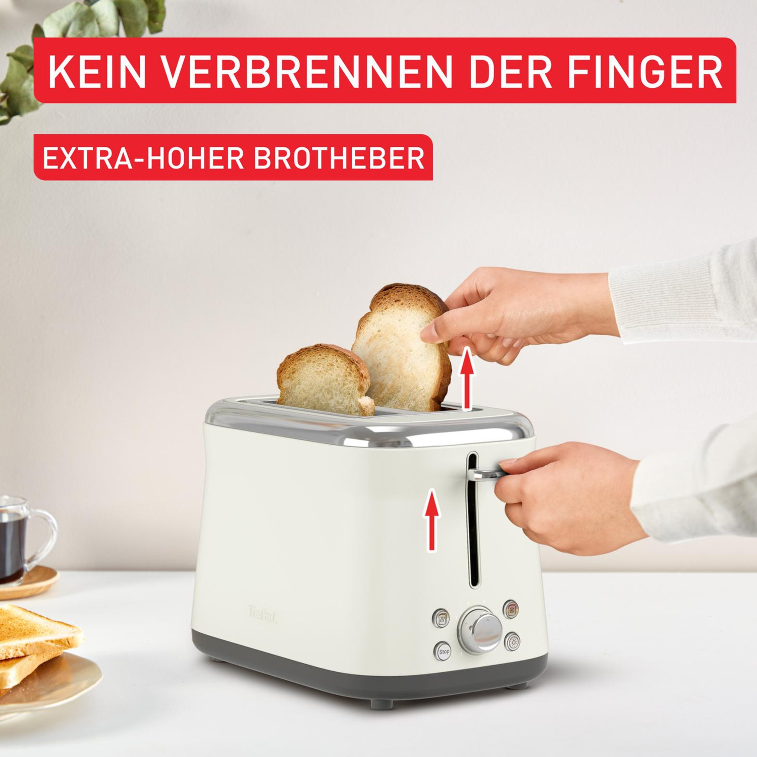 Un grille-pain crème avec du pain grillé qui sort. Des mains tirent le pain grillé. Le texte dit : 'PAS DE BRÛLURES DE DOIGTS'.