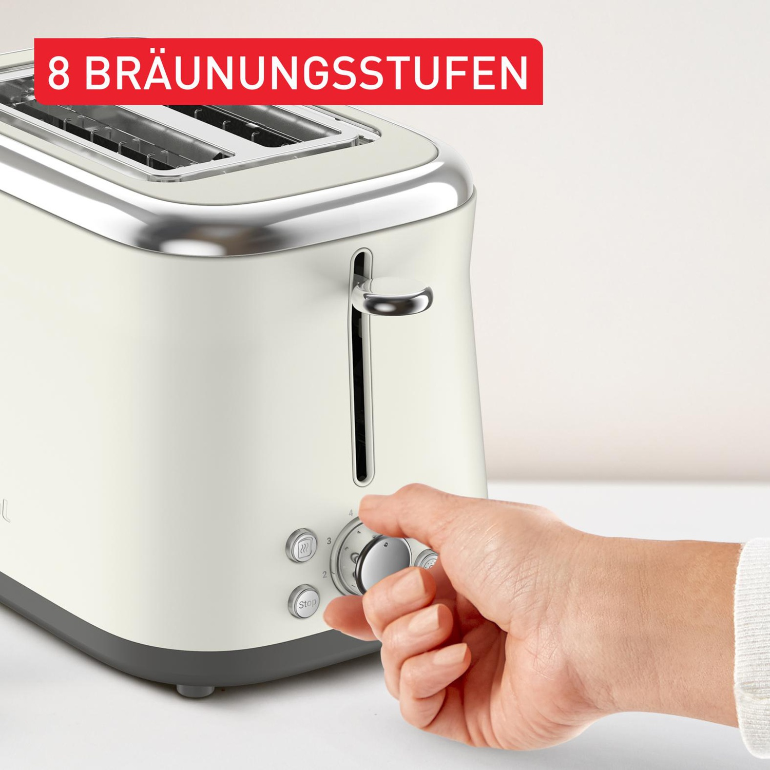 Un grille-pain crème avec des accents chromés. Une main règle le cadran de brunissage. Texte : 8 niveaux de brunissage.