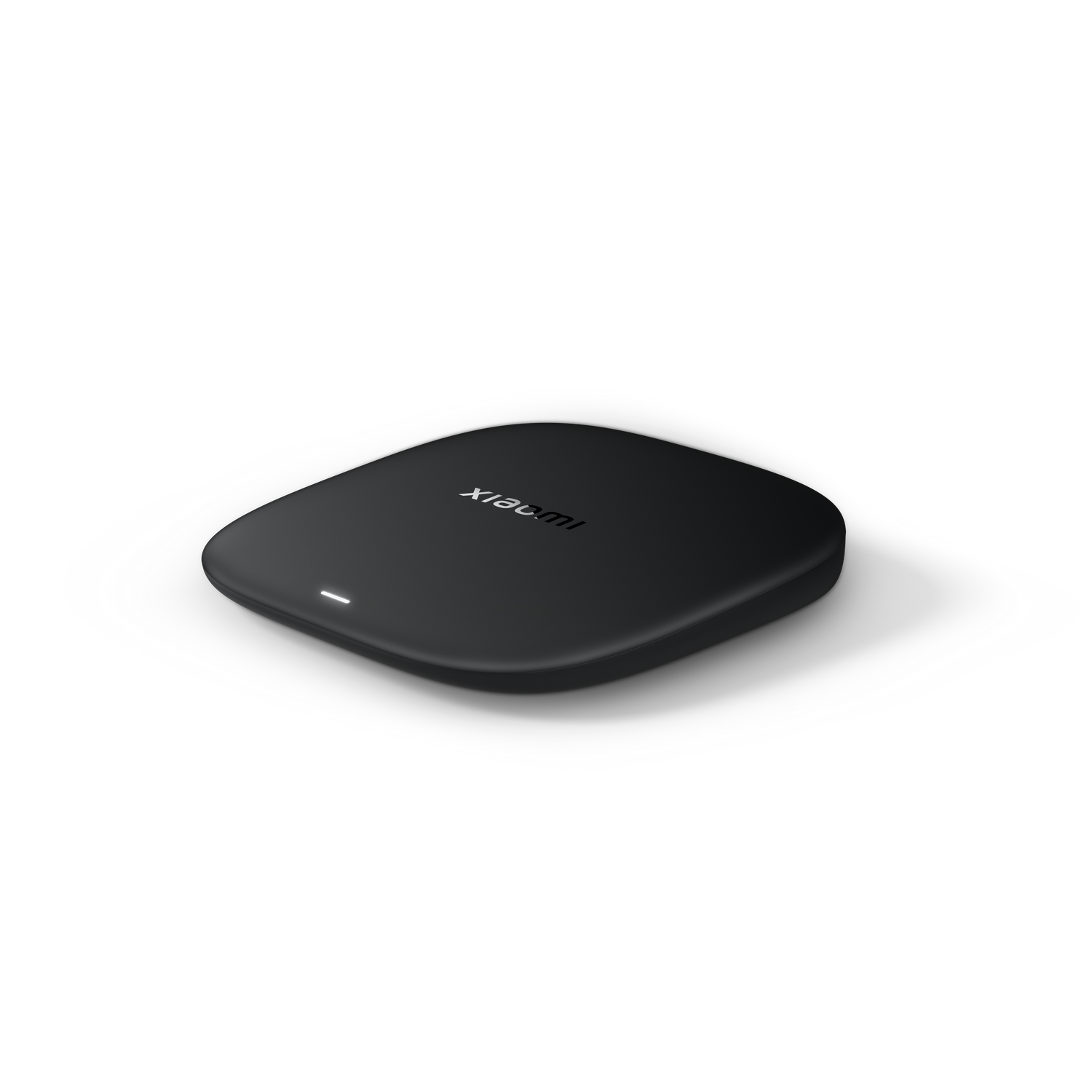 Un cargador inalámbrico Xiaomi negro sobre una superficie gris. El cargador es ovalado con el logo de Xiaomi. Una luz blanca es visible.