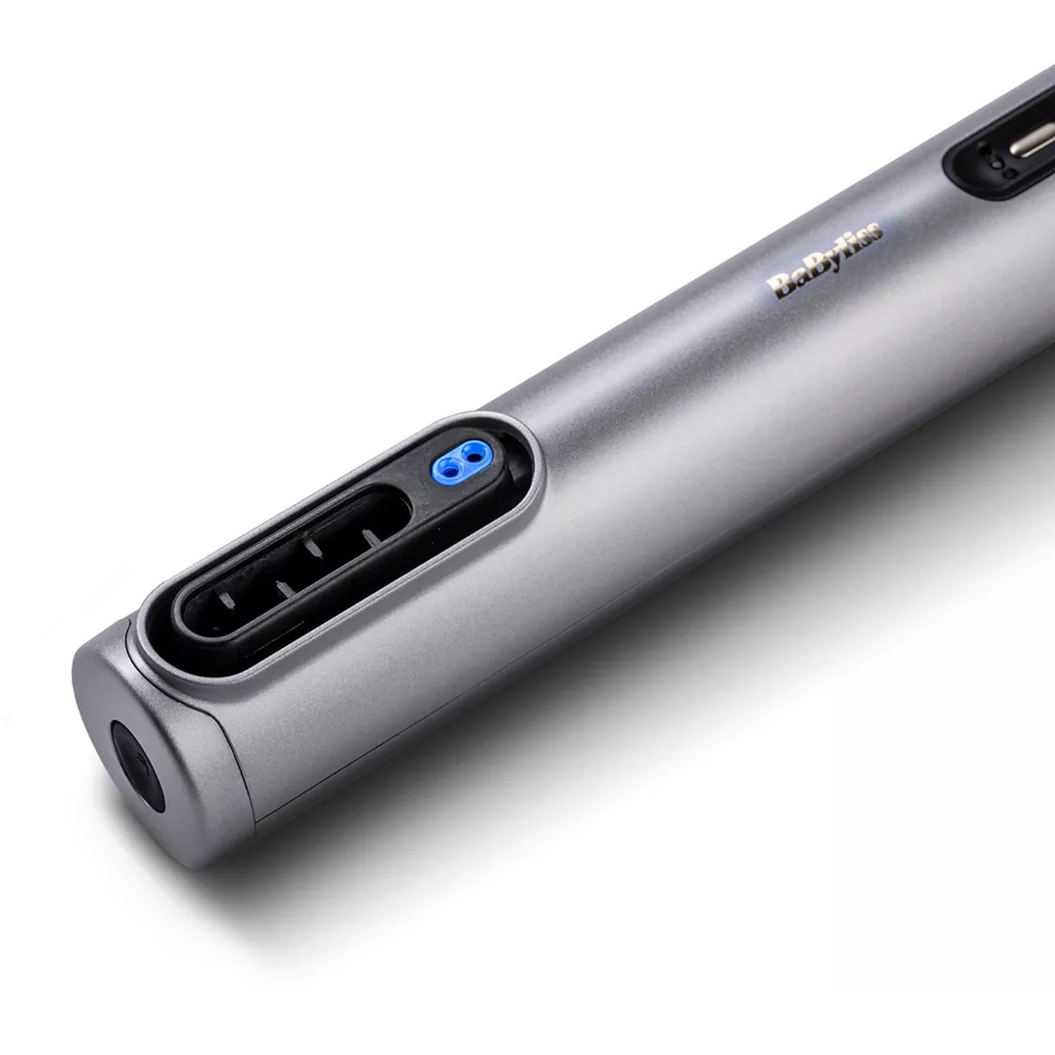 A silver Babyliss hair tool. It has a black nozzle, blue accents, and the brand name is visible on its side.