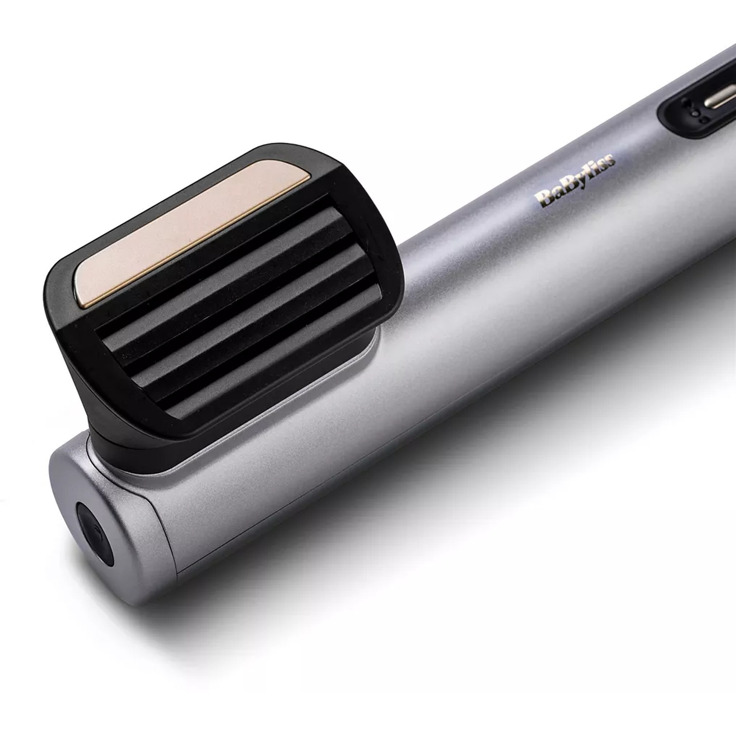 A silver and black hair styling tool. It has a black rectangular head with ribbed vents and a gold accent. The brand is Babyliss.