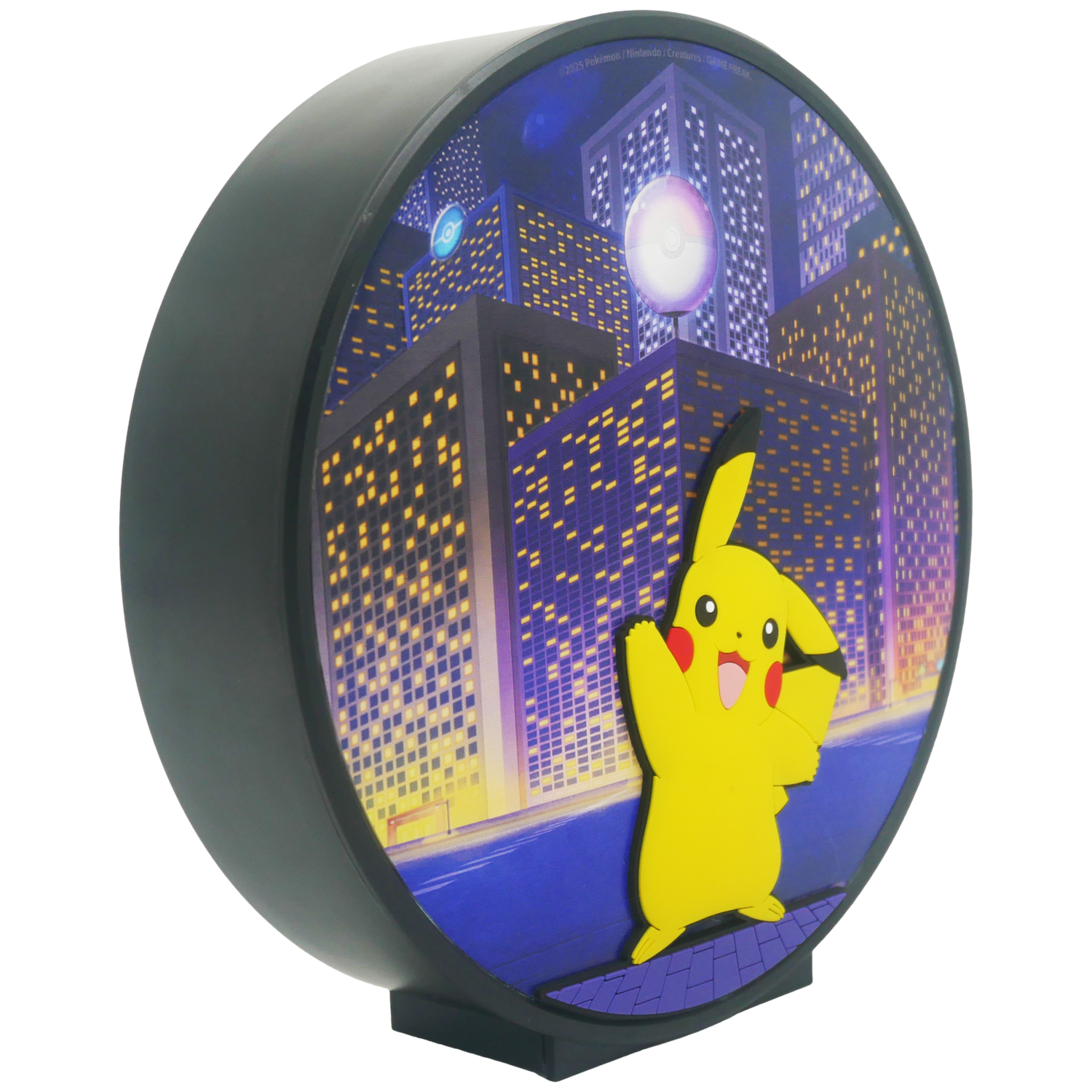 A circular Pikachu night light with a cityscape background. Pikachu stands out in yellow, with tall buildings behind him.