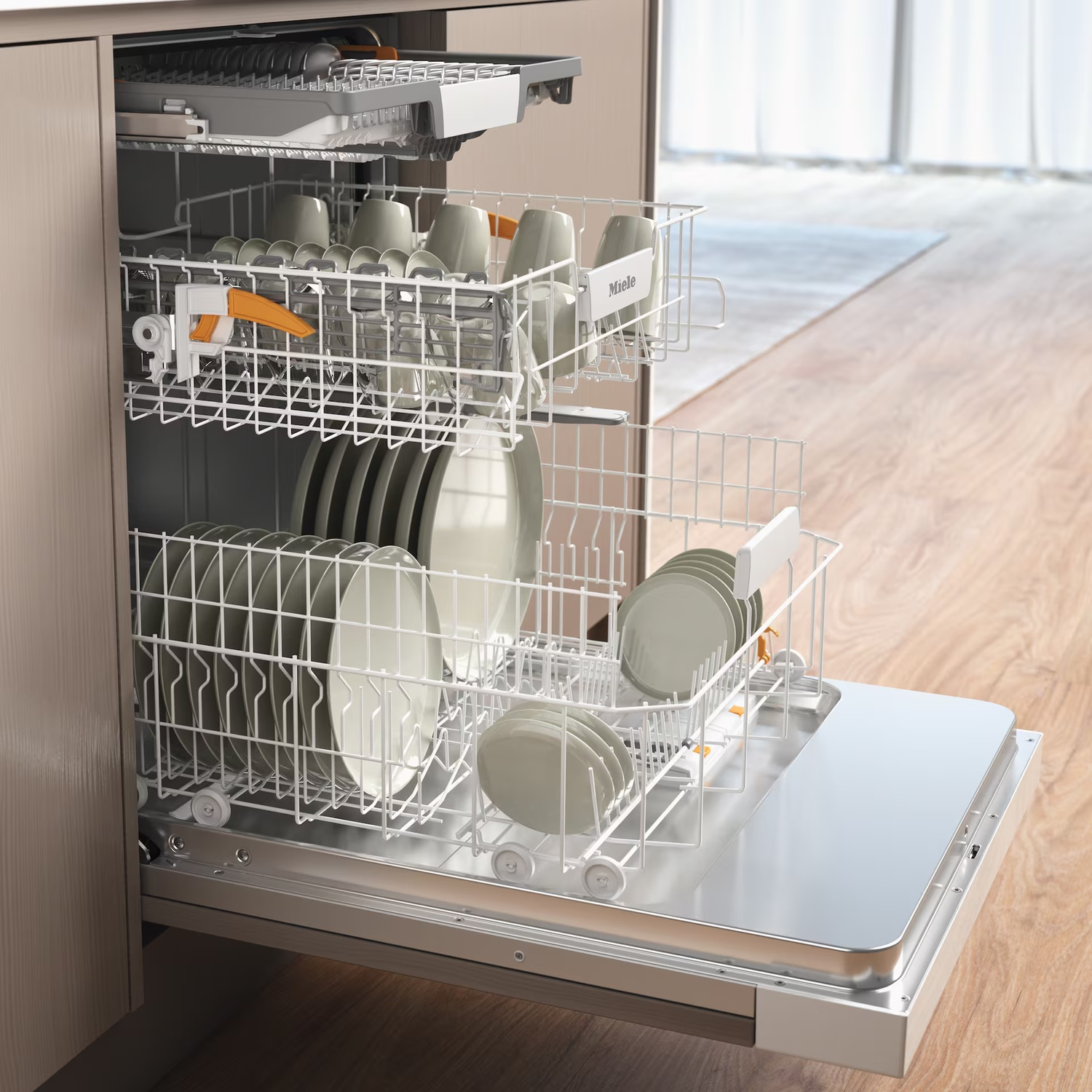 Dishwasher open, filled with dishes. Plates, cups, and utensils are visible. Wooden floor and cabinets surround the appliance.