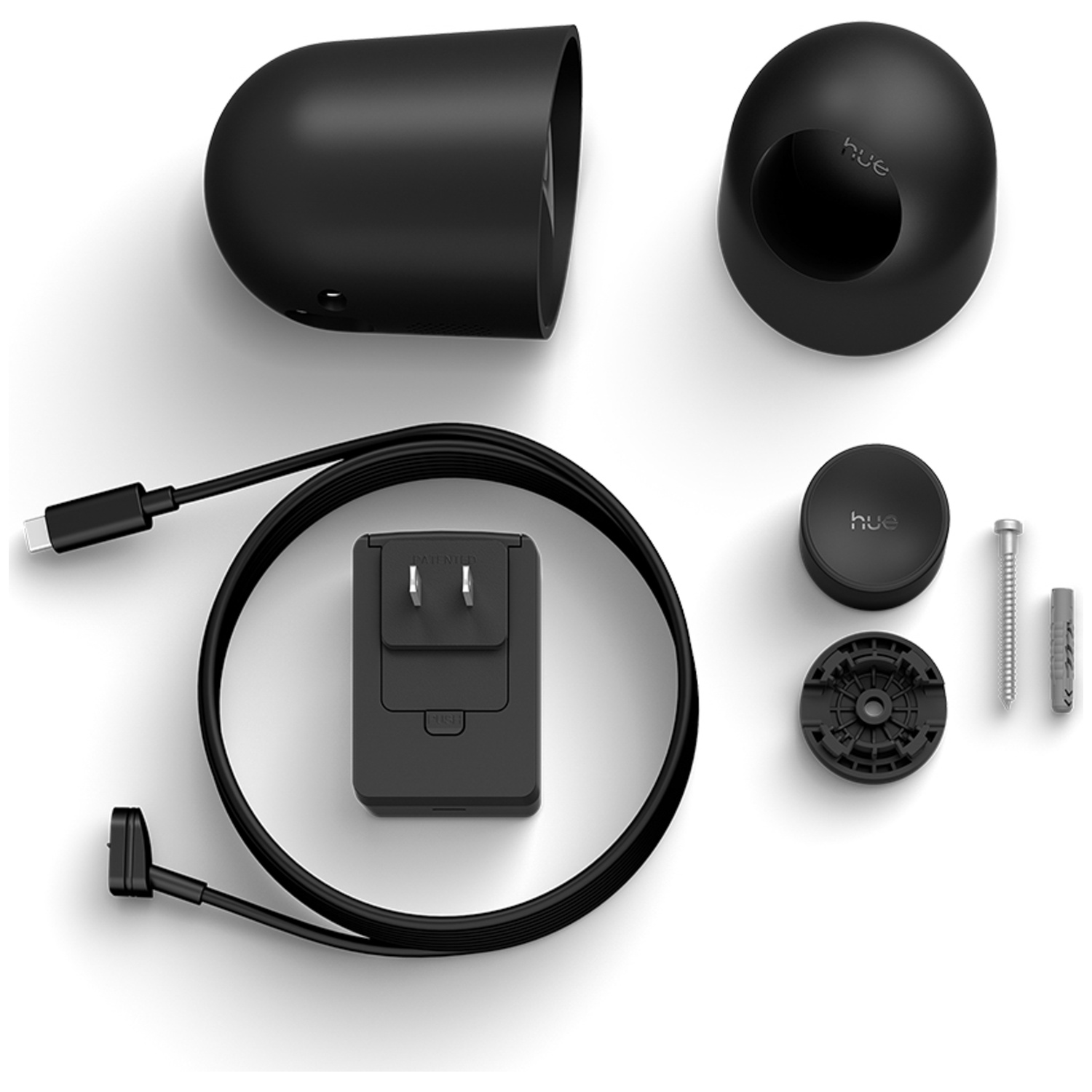 Black Hue components laid out: charging base, charger, cable, small round parts, screws, and a wall plug. All on a white background.