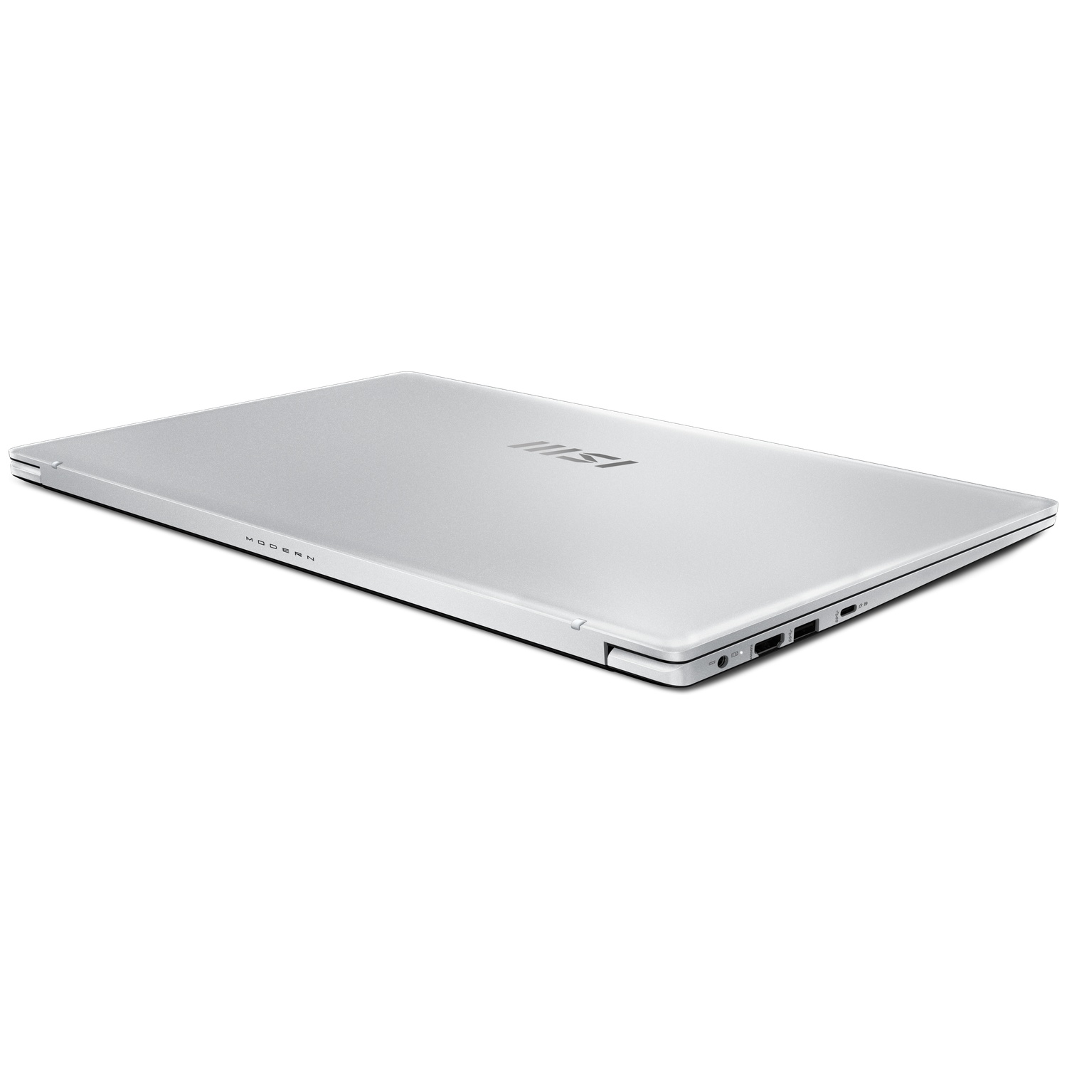 A silver laptop is slightly angled on a white surface. The MSI logo is visible. 'MODERN' is printed on the bottom edge. Ports are visible.