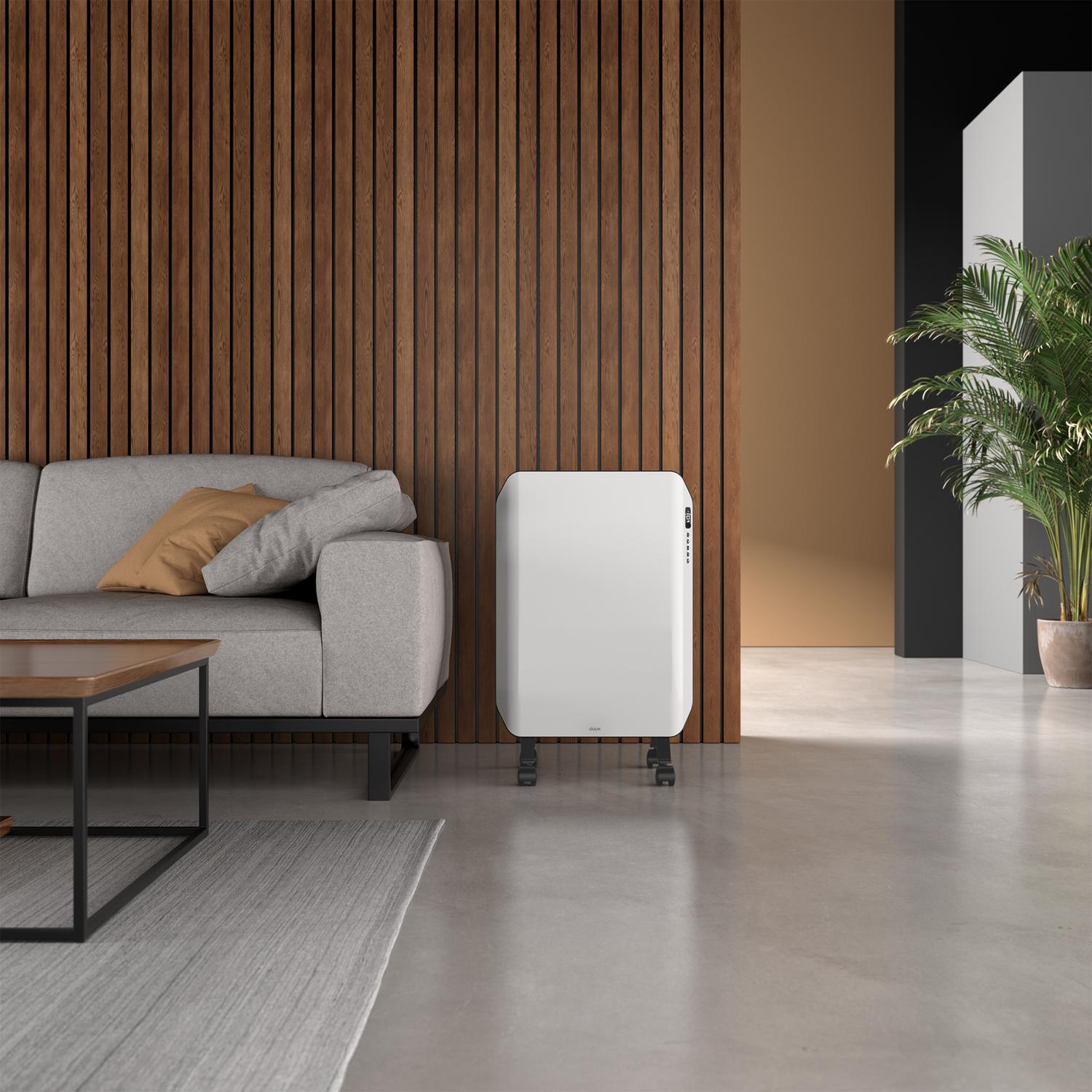 Woonkamer: grijze bank, houten muur, witte kachel, salontafel en een plant. De vloer is beton.
